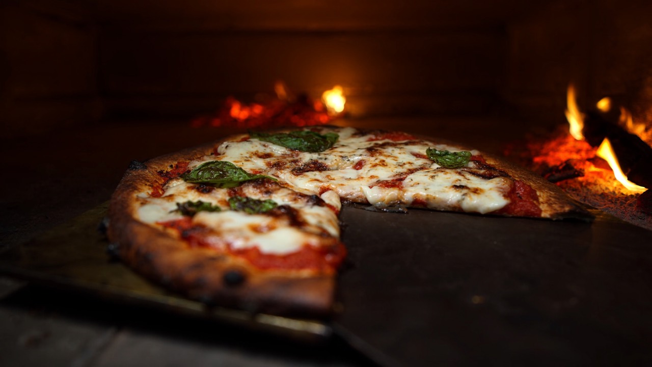 Lit wood-fired pizza oven